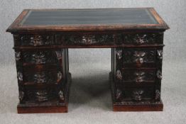 Pedestal desk, late 19th century carved oak with Green Man mask handles and tooled leather inset