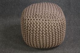 A contemporary knitted pouffe. H.43 W.50 D.50cm.