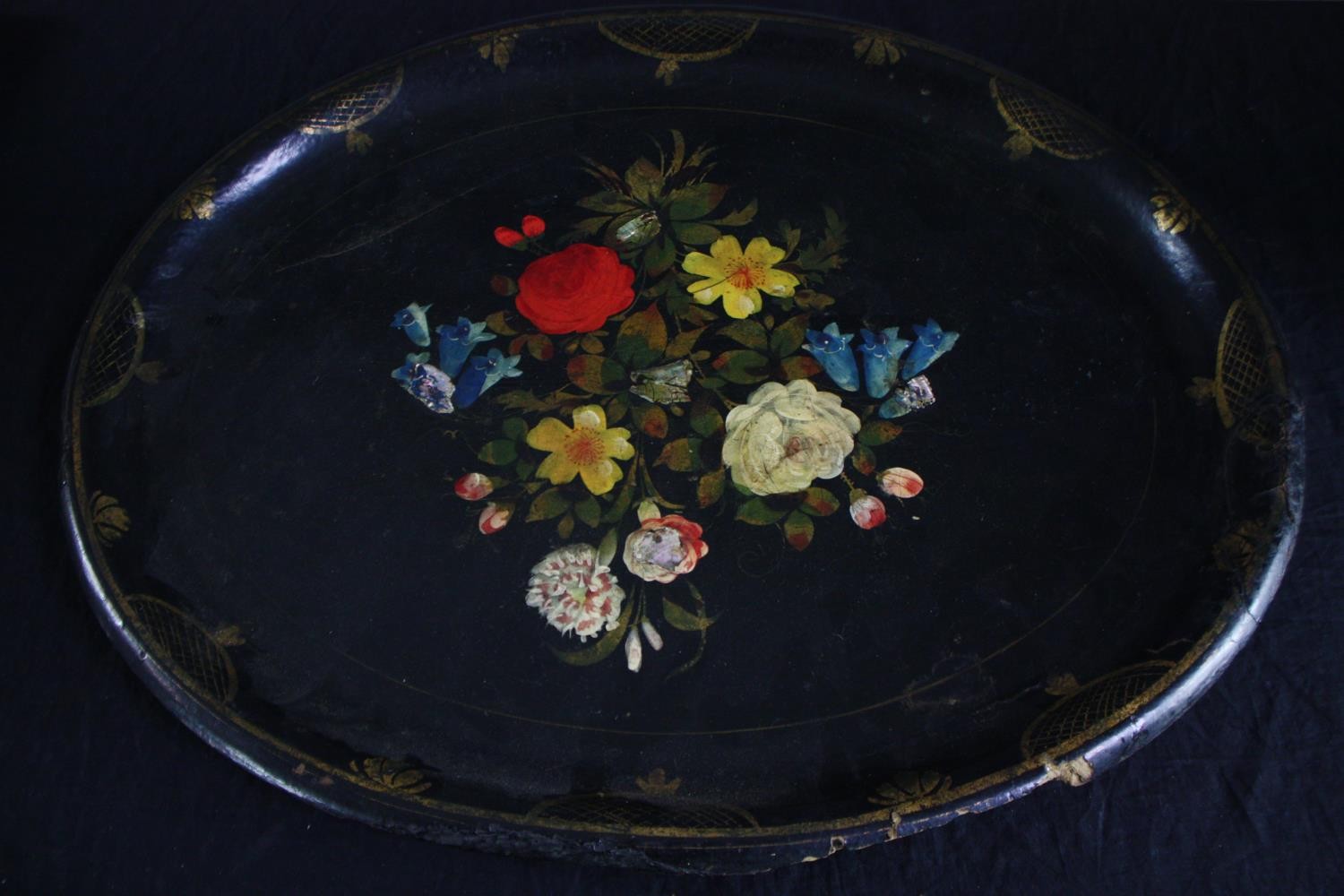 A twentieth century lacquered paper mache tray with floral decoration supported by an iron stand. - Image 3 of 6