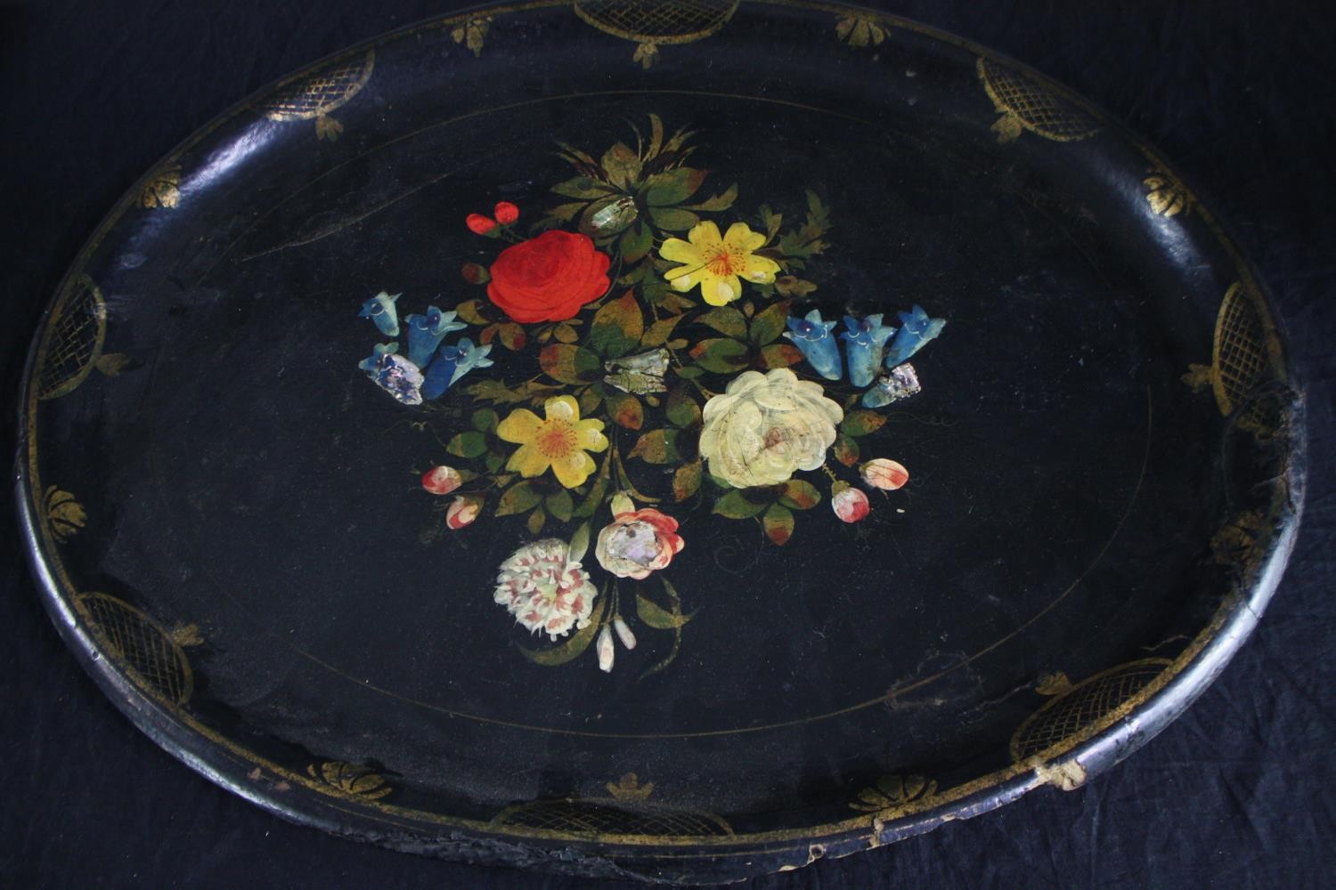 A twentieth century lacquered paper mache tray with floral decoration supported by an iron stand. - Image 4 of 6