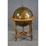 A drinks cabinet in the form of a globe with a fitted interior on a turned beech stand. H.100 Dia.