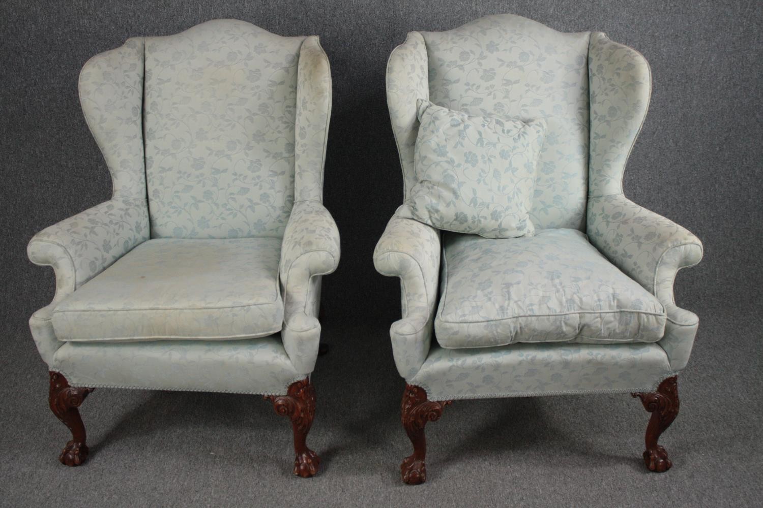 Armchairs, early Georgian wingback style on carved walnut cabriole supports.