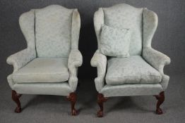 Armchairs, early Georgian wingback style on carved walnut cabriole supports.
