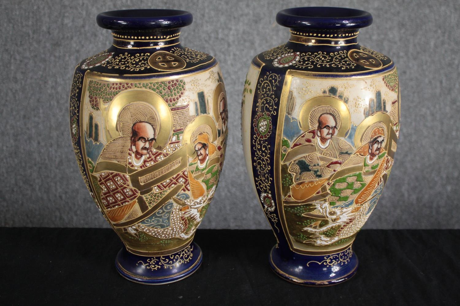 A pair of early 20th century ceramic satsuma hand painted Japanese vases in raised relief