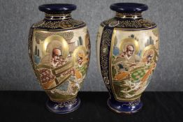 A pair of early 20th century ceramic satsuma hand painted Japanese vases in raised relief