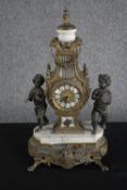 An Italian reproduction mantle clock. Brass with a and marble base and two cherubs. H.52 W.34 D.