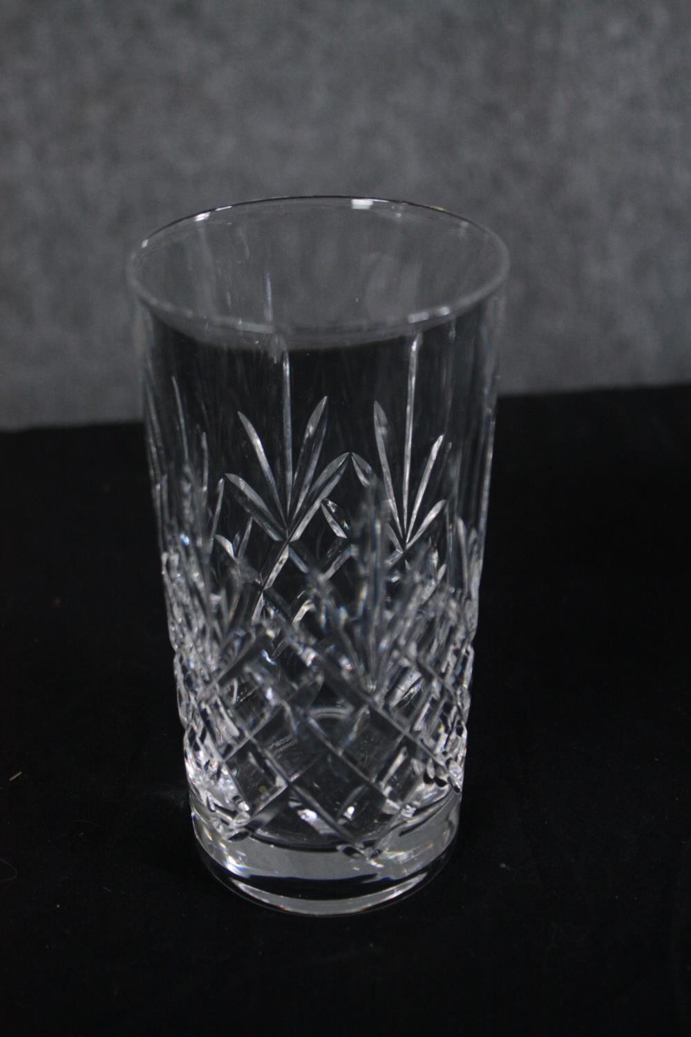 A crystal decanter with two sets of tumblers. H.28cm. (largest)