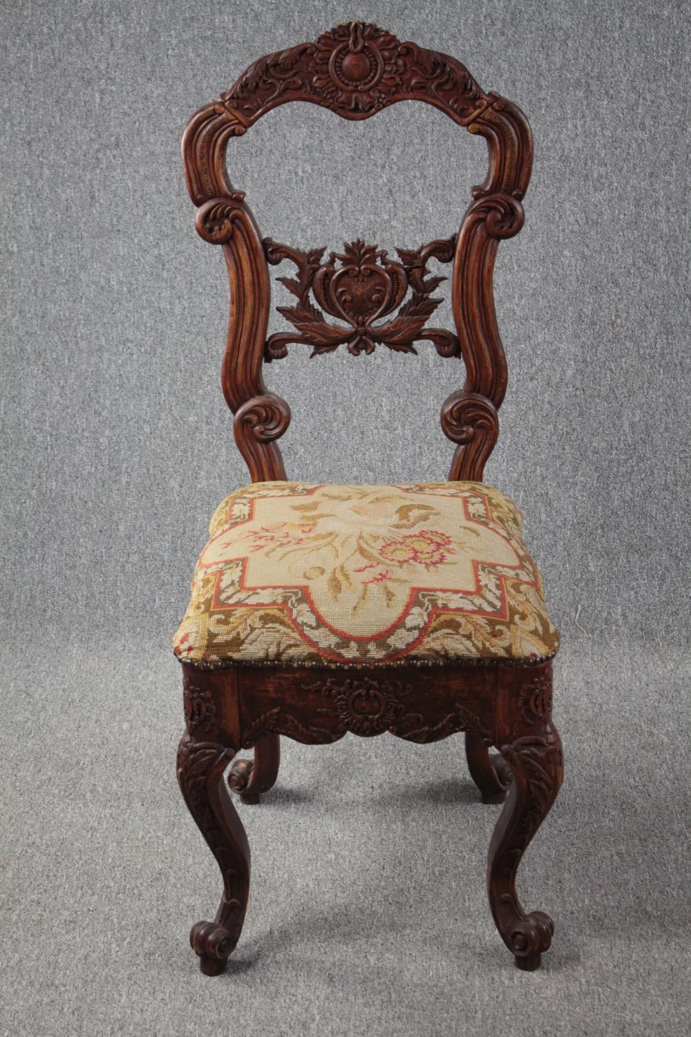 An Eastern carved hardwood side chair. H.118cm.