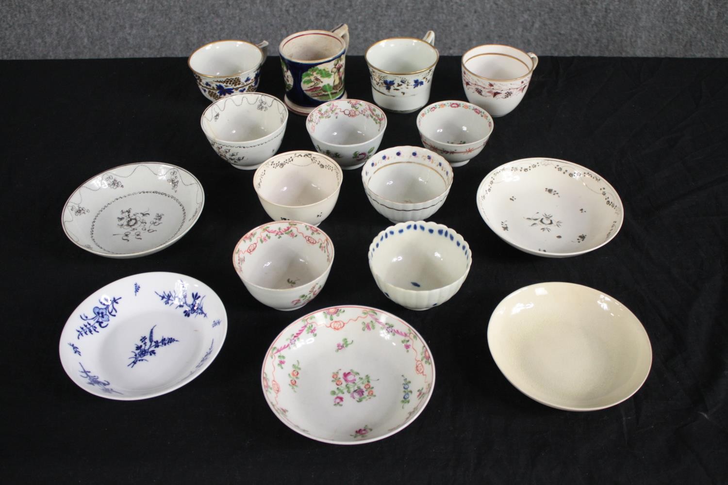 A mixed collection of 19th century cups, tea bowls and saucers. Dia.14cm. (largest)