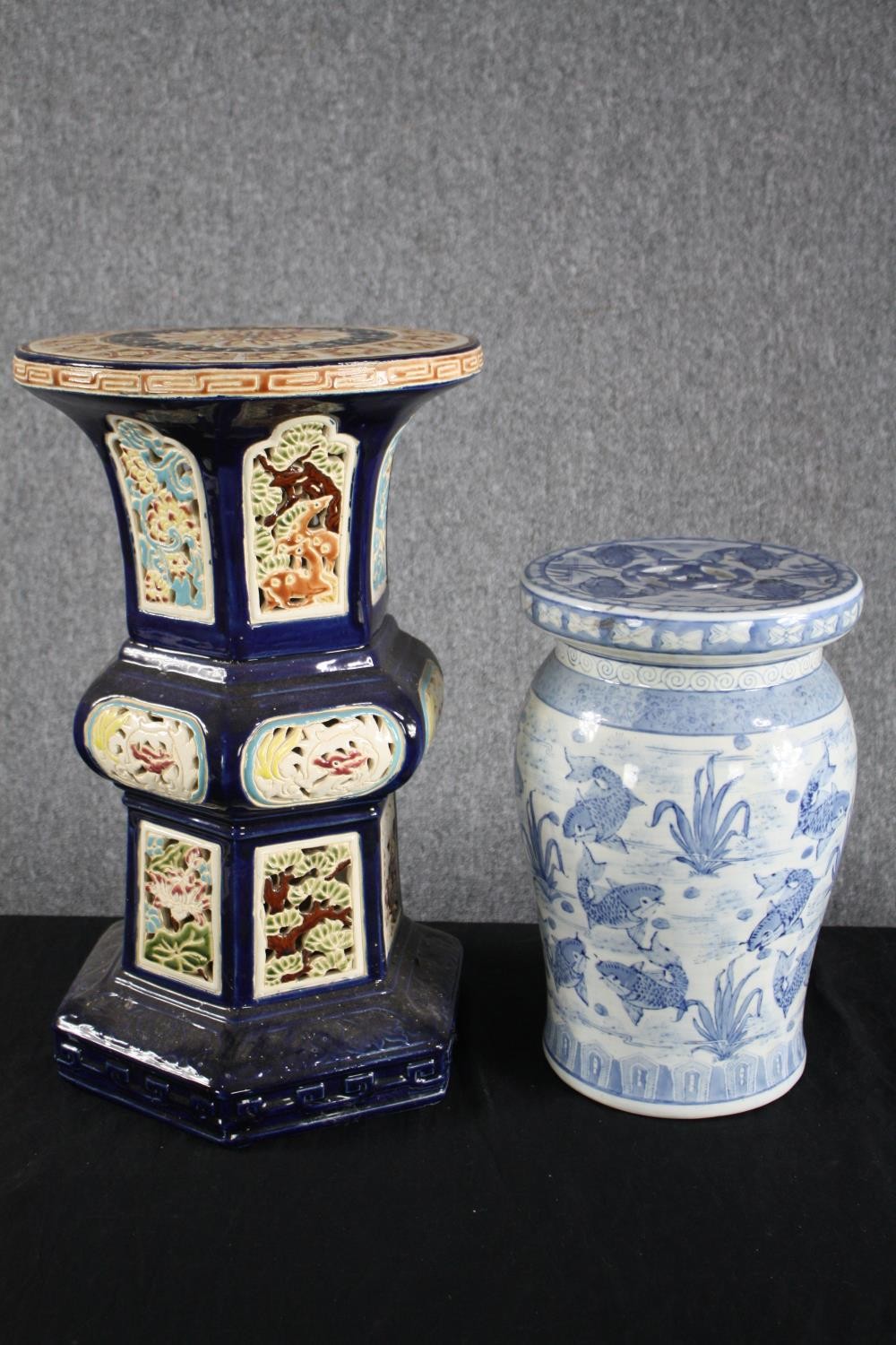 Two modern oriental style ceramic garden stools. Hand painted and decorated with carp. H.41cm. H.