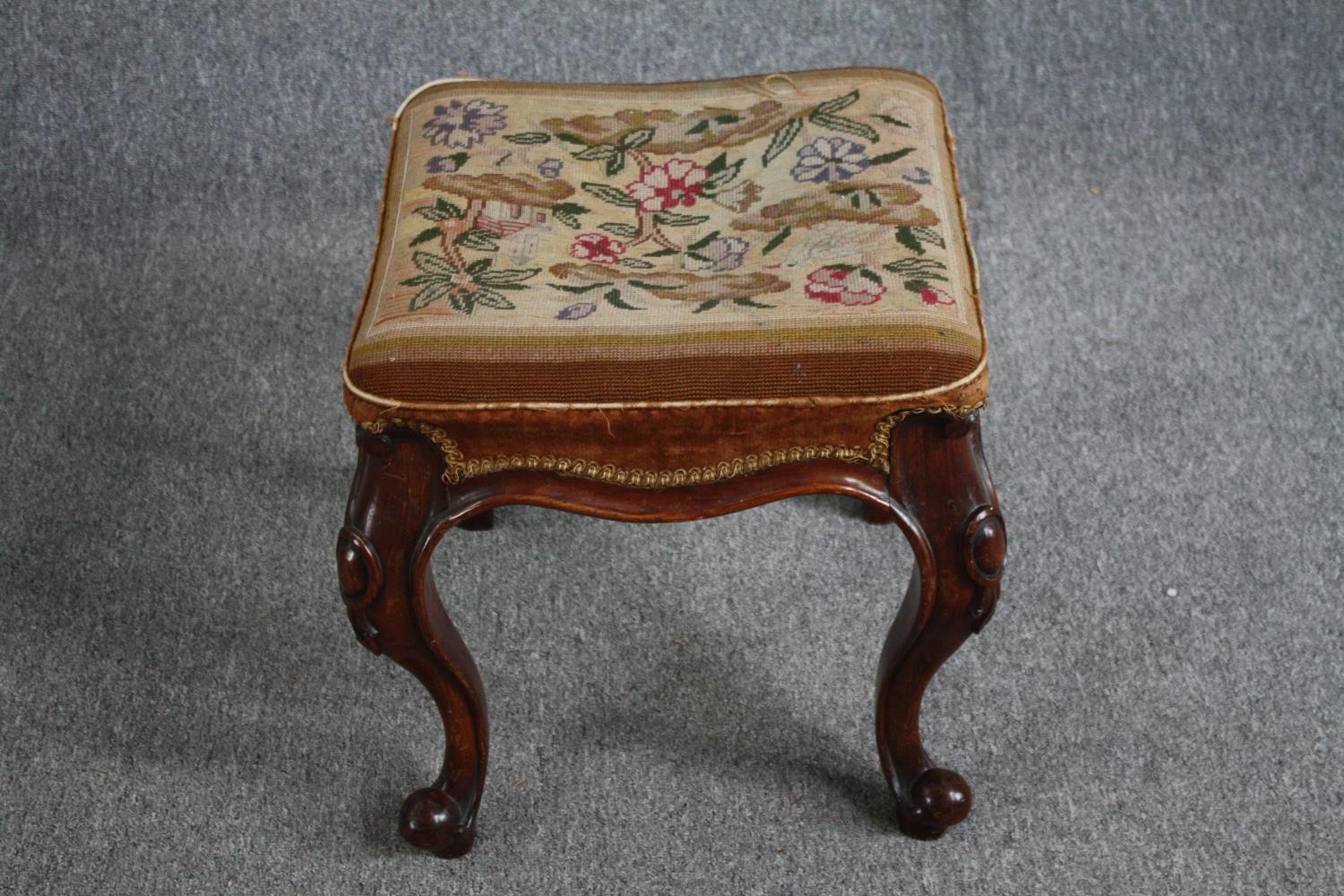 A mid Victorian stool with original tapestry seat on carved mahogany cabriole supports. H.46 W.44