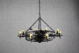 A gothic style candle chandelier. In a black finish with and candle holders. Dia.70cm.