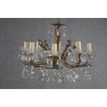 A small French foliate design chandelier with seven branches. Decorated with hanging teardrop