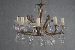 A small French foliate design chandelier with seven branches. Decorated with hanging teardrop
