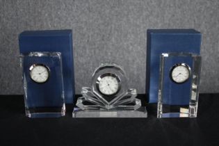 A collection of three Windermere table clocks set in crystal glass. Two are still in their packaging