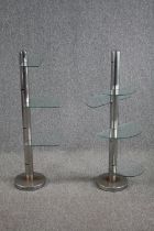 A pair of Art deco display stands with semi circle glass shelves. With six tiers of adjustable