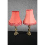 A pair of brass lamps with matching pink shades. H.38cm. Circa 1940. In need of restoration. (each)