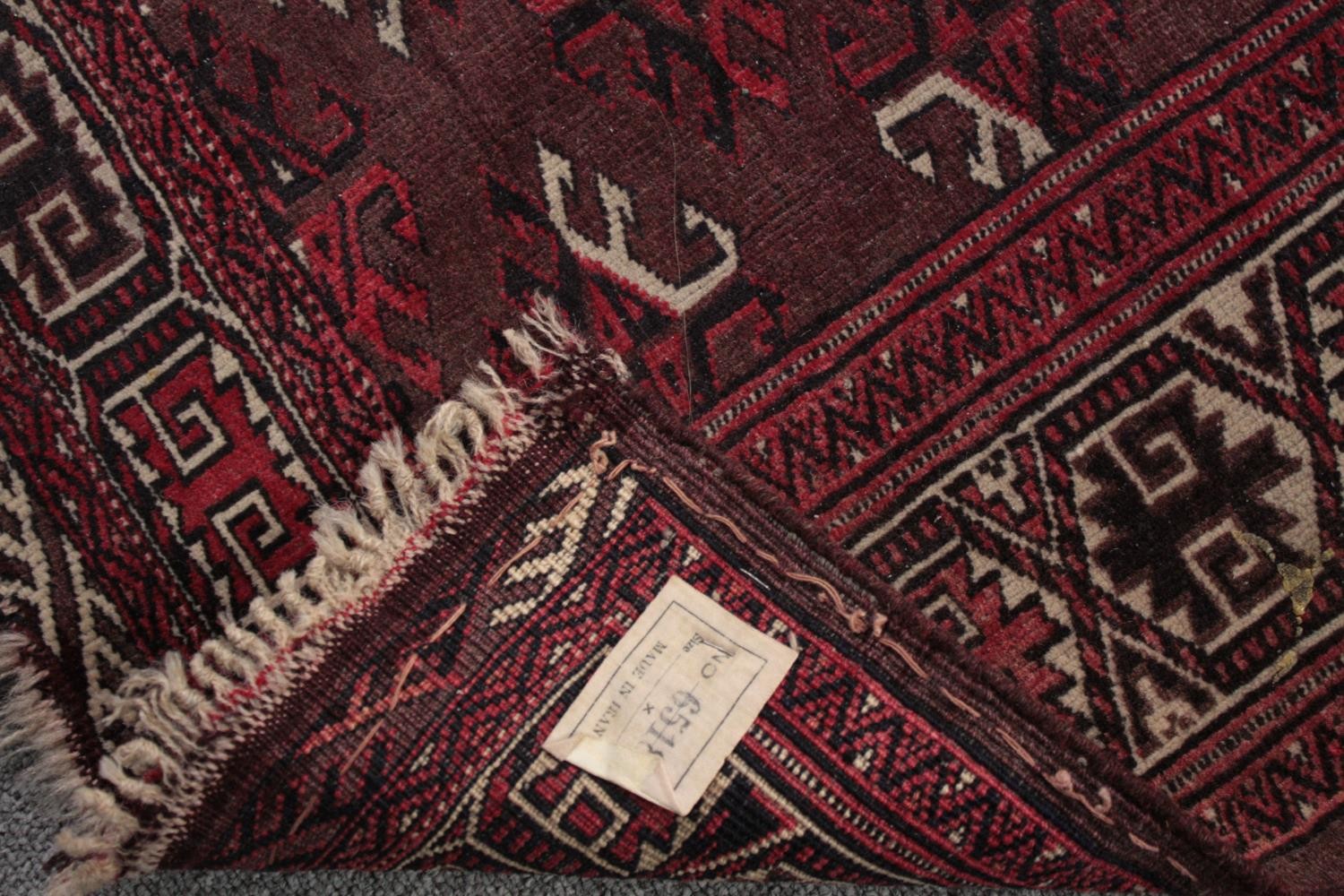 Rug, Belouch with repeating stylised motifs on a burgundy ground within multiple borders. L.167 W. - Image 4 of 4