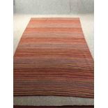 A contemporary flatweave multi-coloured carpet. L.276 W.180cm.