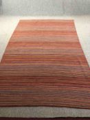 A contemporary flatweave multi-coloured carpet. L.276 W.180cm.