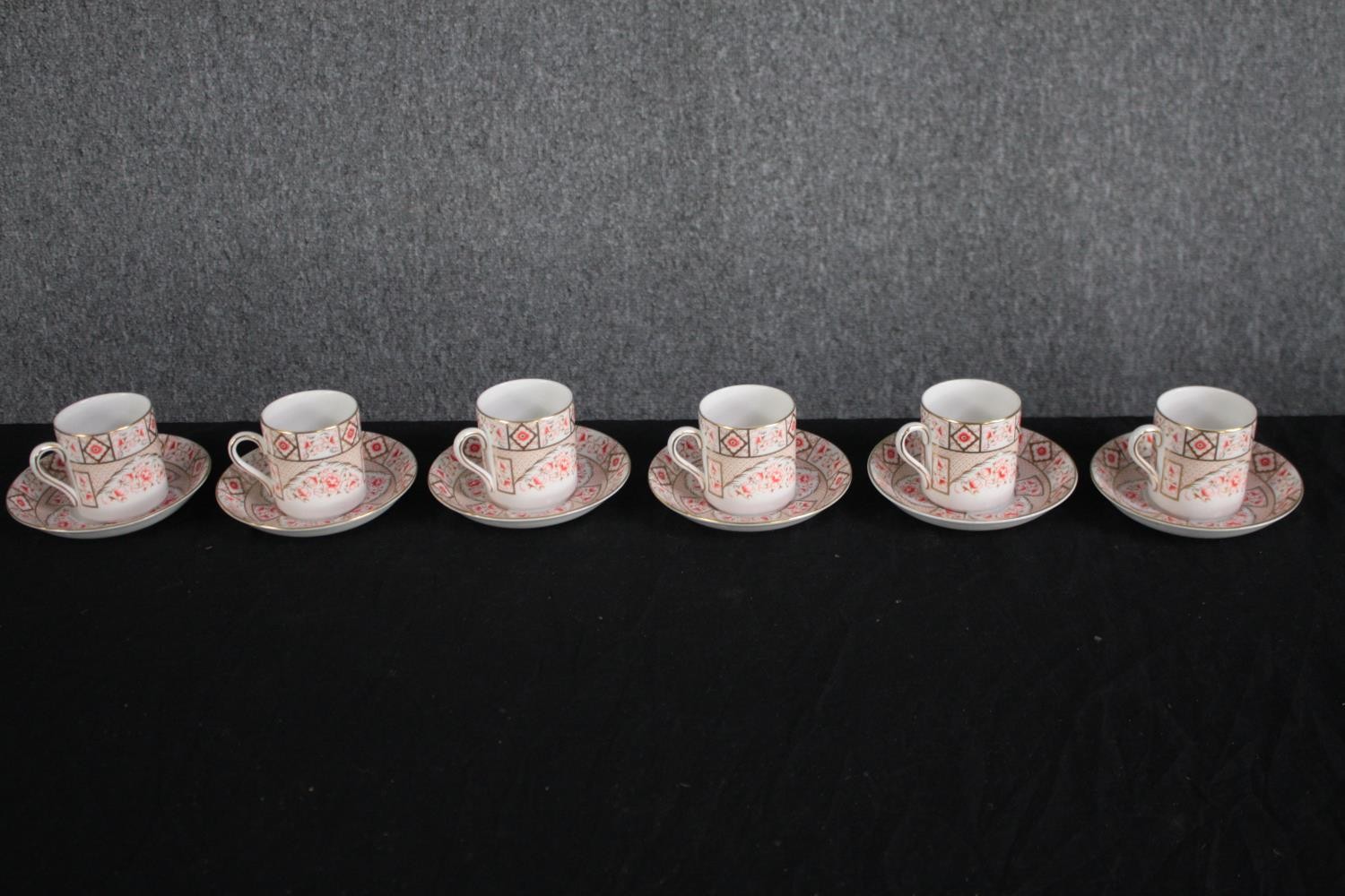 A set of six Royal Grafton china coffee cups and saucers. In a rose and gilt design. Maker's mark to
