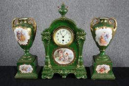 A decorative mantle clock with a matching pair of porcelain urns. Austrian with figural design in