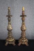 A pair of large casts brass lamps with four legged pedestals and raised Rococo revival style