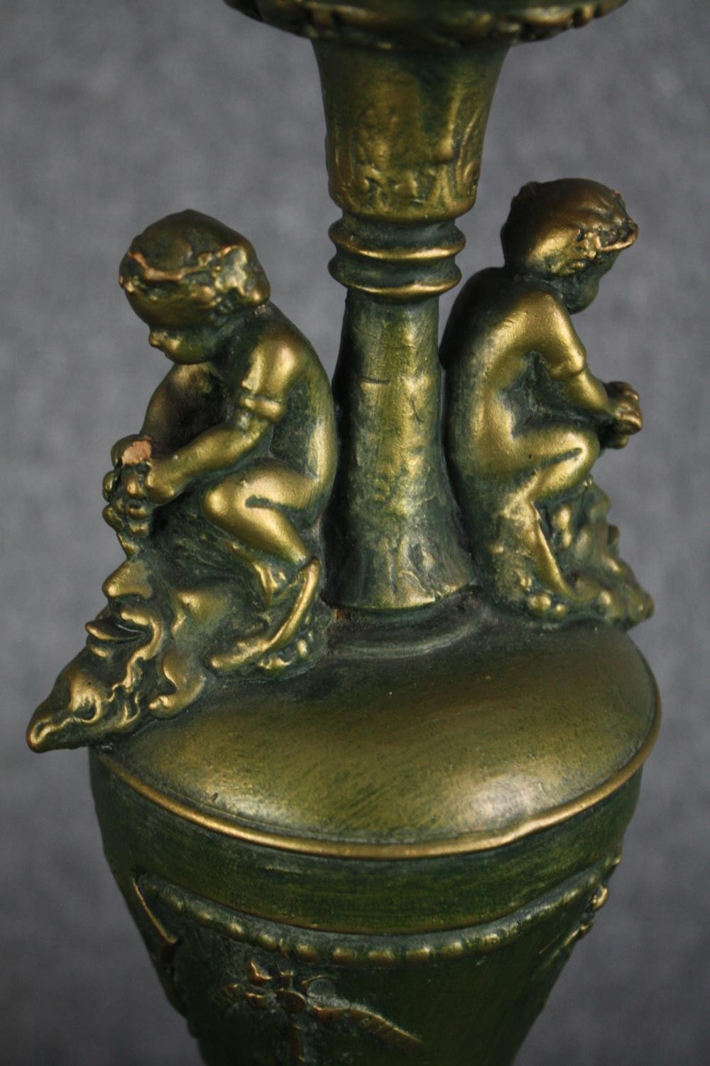 A pair of painted wooden urn design lamps. Decorated with cherubs and a worn greenish gold finish. - Image 3 of 4