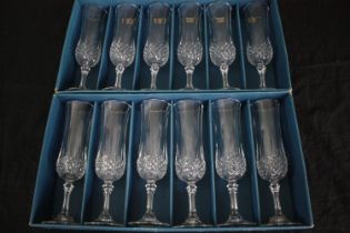 A boxed set of twelve longchamp crystal glasses made by Cristal d'Arques, Paris. H.21cm. (each)