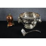 A silver plated repousse punch bowl with five attached cups and a ladle. Also, a copper boiled egg