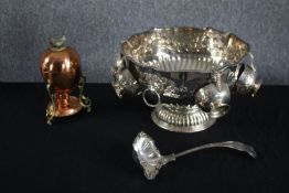 A silver plated repousse punch bowl with five attached cups and a ladle. Also, a copper boiled egg