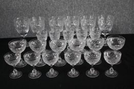 Twenty-three stemmed cut crystal glasses. A mix of wine and sherry glasses. H.16cm. (Largest)