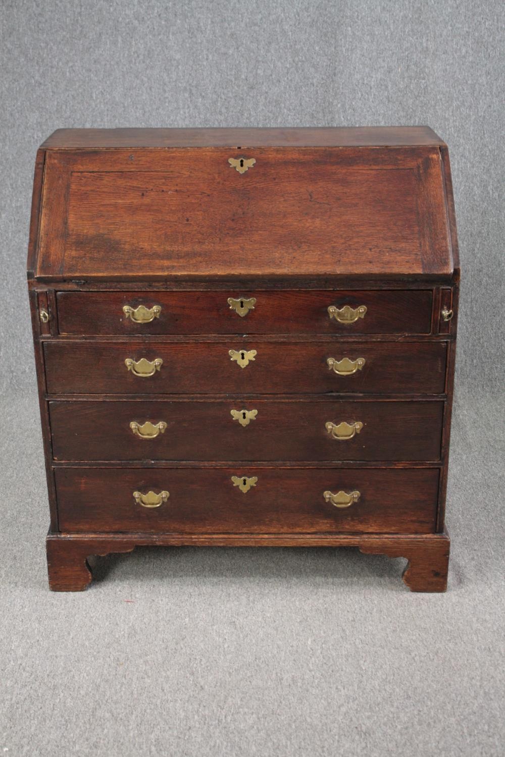 Bureau, Georgian oak with fitted interior. H.101 W.92 D.52cm. (Some wear and tear commensurate