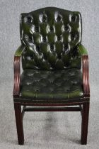 A Gainsborough style library armchair in deep buttoned leather upholstery.