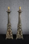 A matching pair of ornate gilt metal pillar lamp stands supported by cherubs. H.63cm. (each)