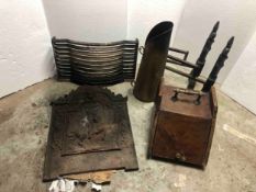 A collection of cast iron fire items, including two coal scuttles, a grate, a back board with knight