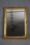 A gilt framed mirror with bevelled plate. H.106 W.75cm.