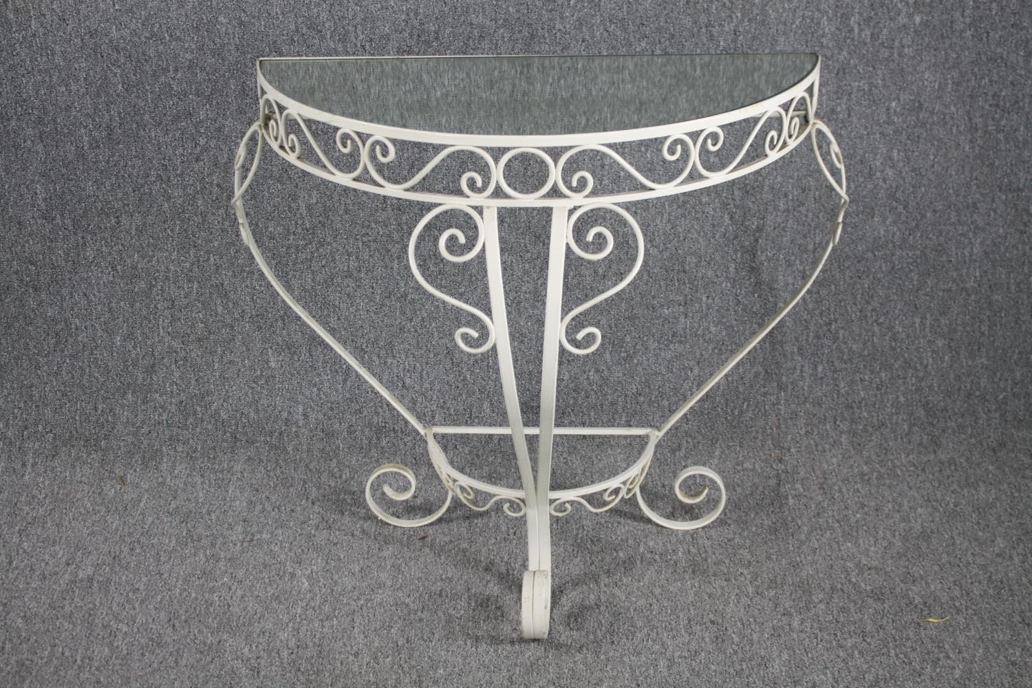 A vintage wrought iron and glass console table. H.77 W.75cm.