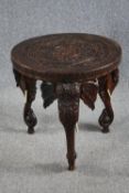 Lamp or occasional table, eastern carved hardwood with elephant supports and bone tusks. H.62 Dia.