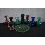 An assortment of 19th and early 20th century coloured blown glass, including Bristol green wine