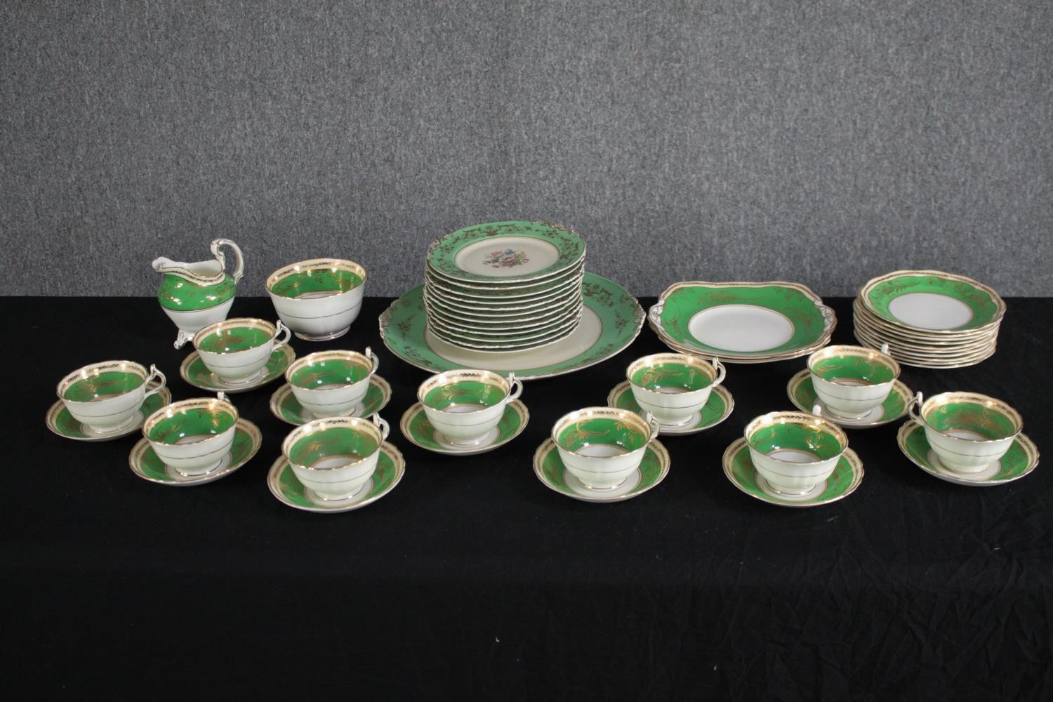 A German porcelain tea set for eleven people. 1930s Konig teacup & saucer, plates and creamer. In