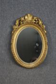 Wall mirror, 19th century gilt with Rococo shell carved cresting. H.68 W.46cm.
