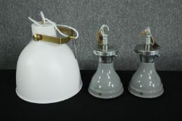 Three modern ceiling lights. A pair of grey lights with an industrial look the other larger and