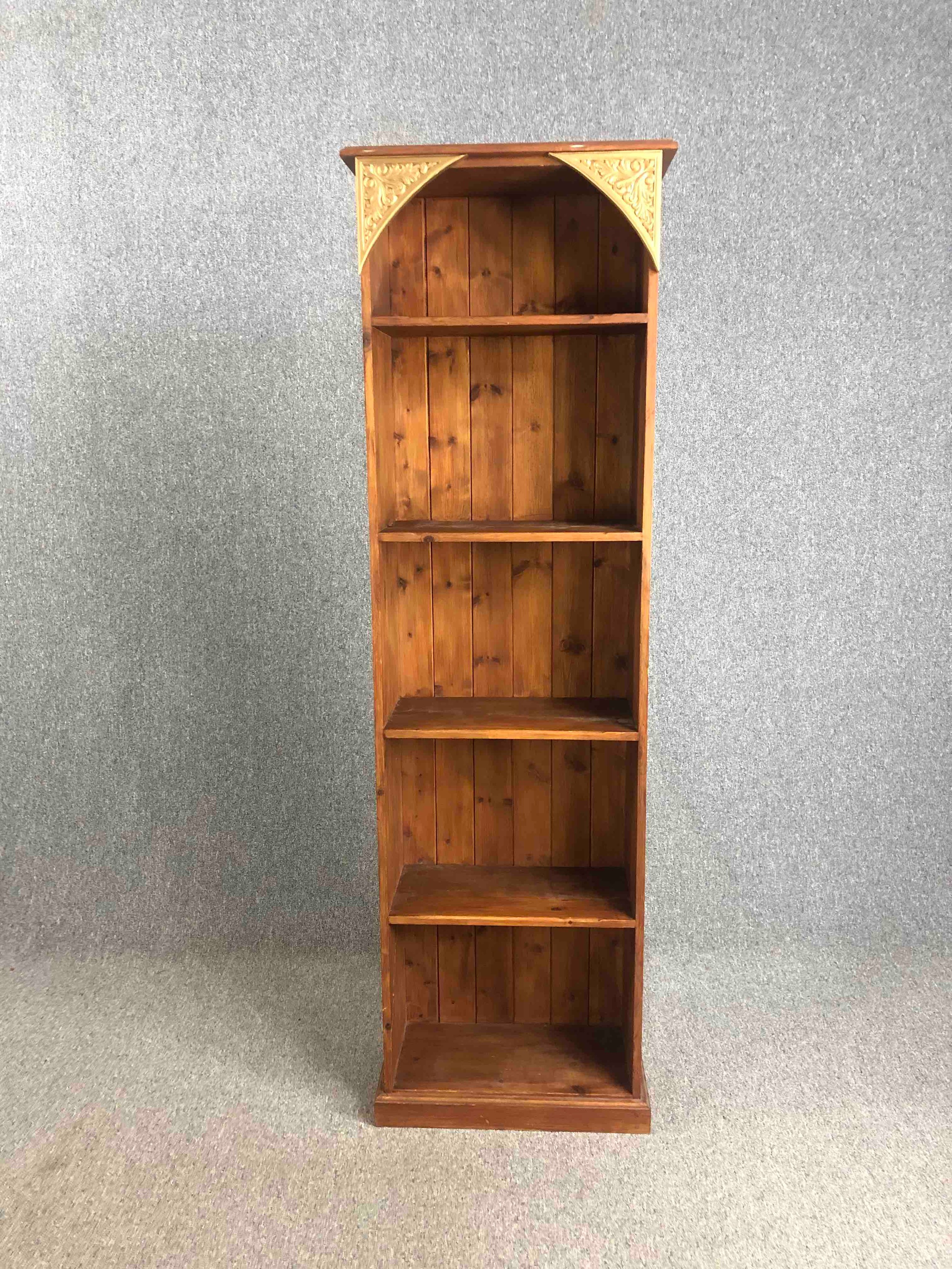 A full height pine open bookcase with carved and painted decoration. H.197 W.60 D.30cm.