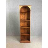 A full height pine open bookcase with carved and painted decoration. H.197 W.60 D.30cm.