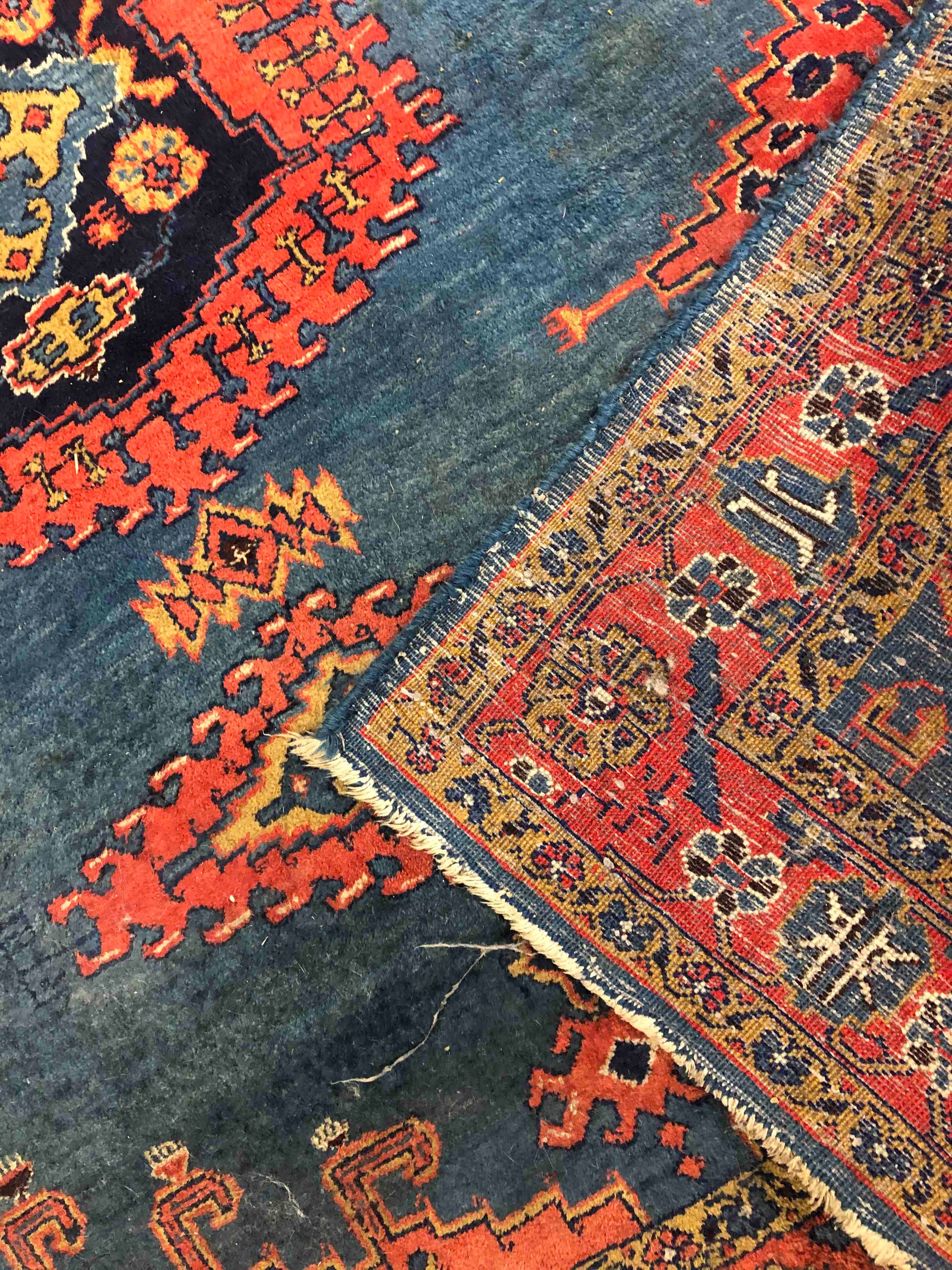 A Persian handmade Senneh rug with geometric designs, dominated by red on a dark blue ground. L. - Image 3 of 3