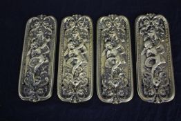 Four brass door plates with repousse cherub design. H.20 W.8cm. (each)