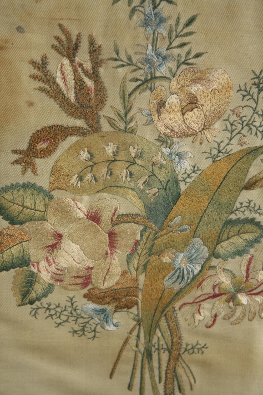 A framed embroidery. Flowers. Early twentieth century. Framed and glazed. H.42 W.35cm.