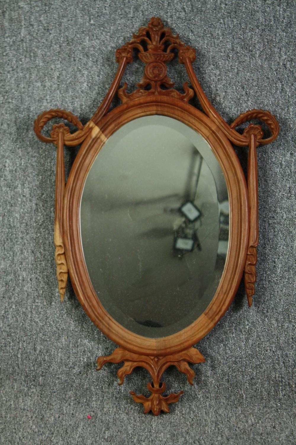 Wall mirror, 19th century style carved hardwood with swags and husks and fitted with a bevelled