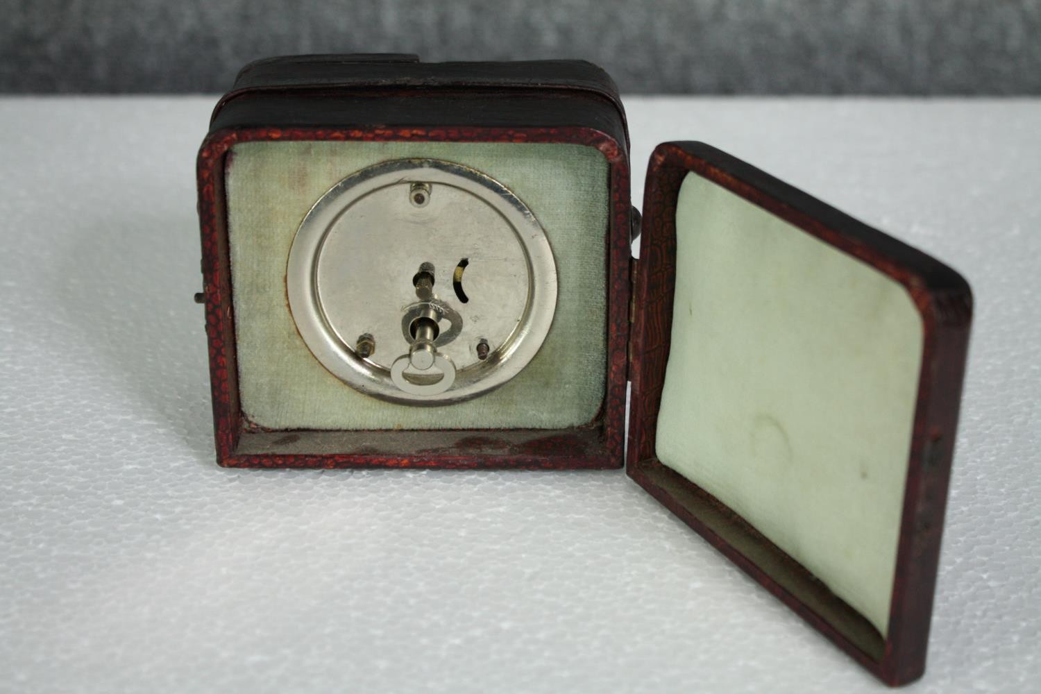 A 1930's wind-up travel clock in a leather case. H.8 W.10 D.9cm. - Image 4 of 5